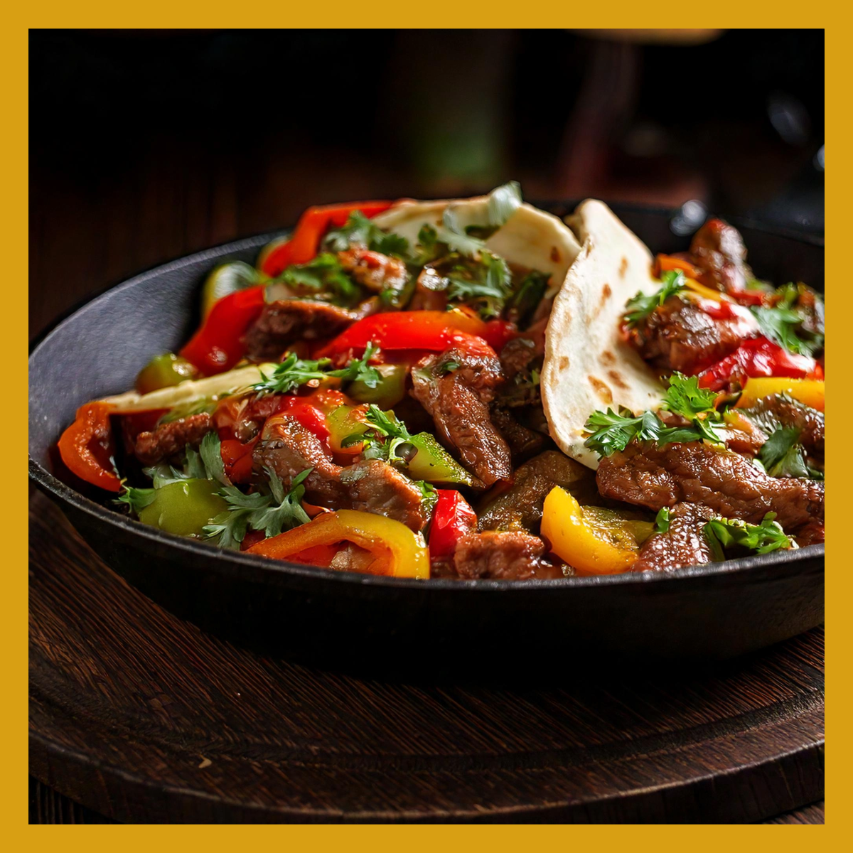 a fajita skillet with beef fajita meat, grilled peppers and onions, and tortillas